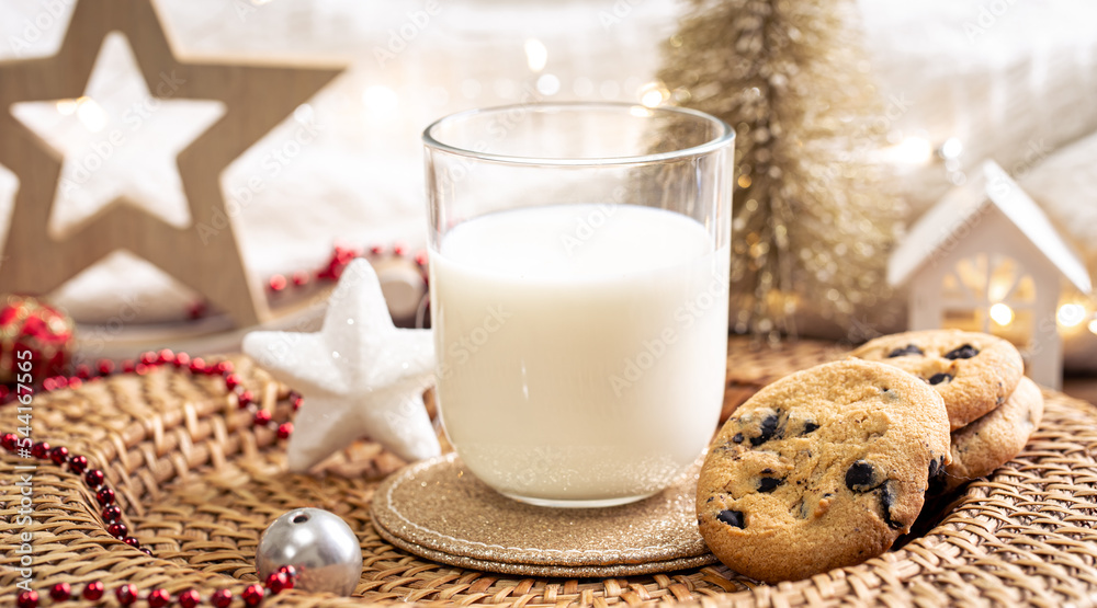 Christmas cookies and glass of milk for Santa on holiday blurred background. Christmas cookies and glass of milk for Santa on holiday blurred background.