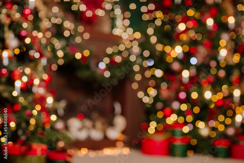 Blurred room with Christmas decor. Holiday atmosphere with lights and tree