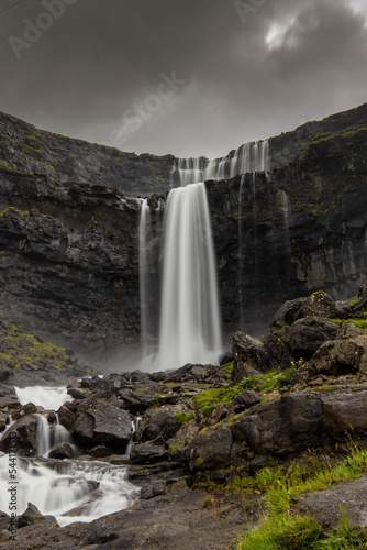 Waterfall on the rocks. Beautiful Faroe Islands. Discover wild nature of Scandinavia. 
