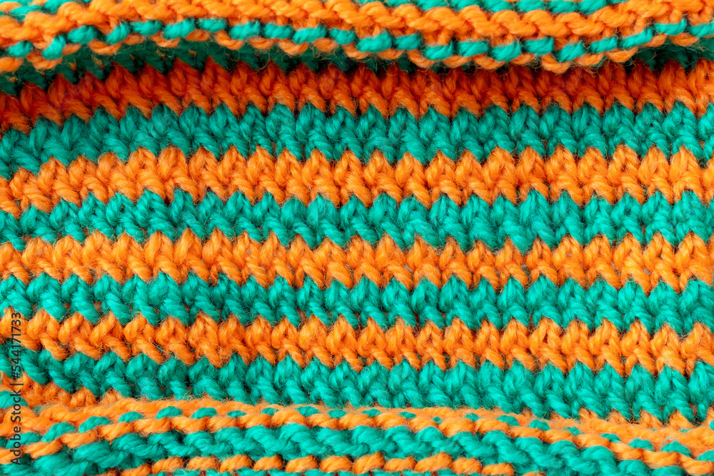 Striped orange green wool knitted fabric texture background
