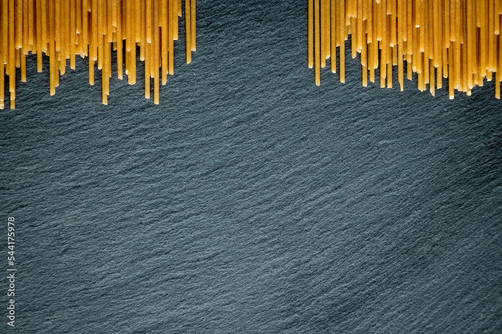 Italian spaghetti on a black slate stone background with space for your text. concept. geometry. food. style