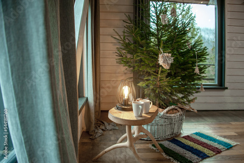 Ukrainian Carpathians in the window of a country house. Lamp in traditional style. National style. Christmas
