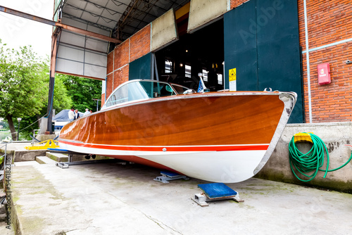 Vinage wooden motor boats in shipyard photo