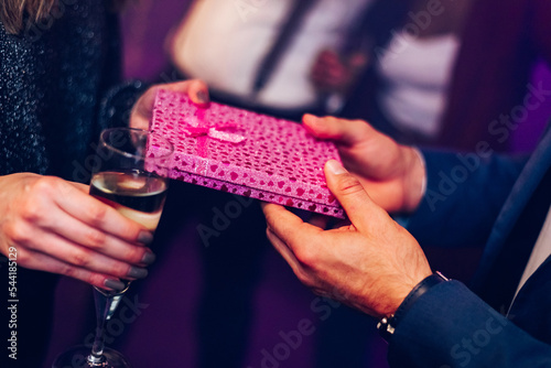Couple exchanging gifts while on the birthday party or new years eve