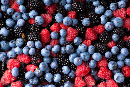 close up view of fresh ripe mixed Blueberries, blackberries and raspberries as flatlay background