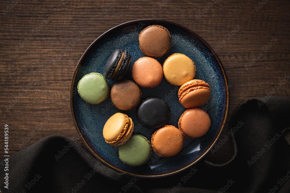 Sweet macaron dessert. Colorful macarons on plate. Top view. Sweet macaron dessert. Colorful macarons on plate. Top view.