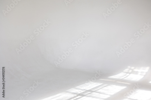 Clear white cyclorama. Light background with sun light and shadows. Plain wall empty photo studio. . High quality photo photo