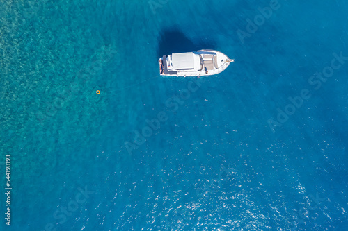 Aerial view beautiful white yacht on clear blue sea in Turkey. Concept cruise travel by drone