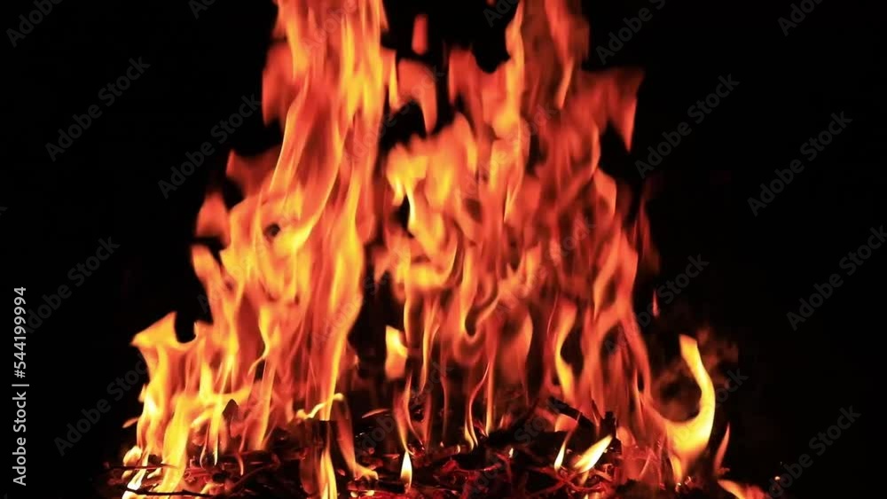 Bonfire flame on a black background. Fire on a dark background. Rest in the camping. Texture, abstract background. Bonfire flame on a black background. Fire on a dark background. Rest in the camping. Texture, abstract background.