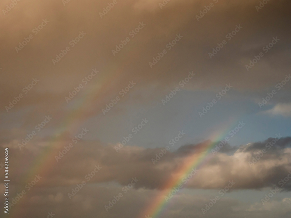Dramatic cloudy sky with rainbow symbol of luck. Nature phenomenon. Dramatic cloudy sky with rainbow symbol of luck. Nature phenomenon.