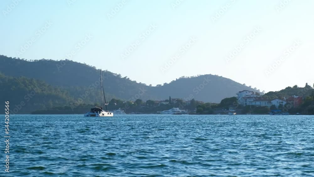 Alone yacht carries tourists in sea. A view of nice white alone yacht diving in the empty blue sea in summer. A concept of luxury recreation during summer holiday. Alone yacht carries tourists in sea. A view of nice white alone yacht diving in the empty blue sea in summer. A concept of luxury recreation during summer holiday.