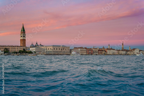 View of Venice Grand Canal and Santa Maria della Salute church in the evening and sunset. Piazza San Marco from river. Gondola and boats traditional. Carnival and mask. Italy holidays on winter. Chris