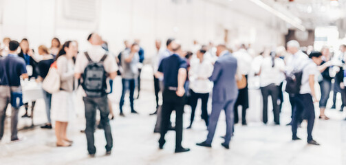 Abstract blurred people socializing during coffee break at business meeting or conference.