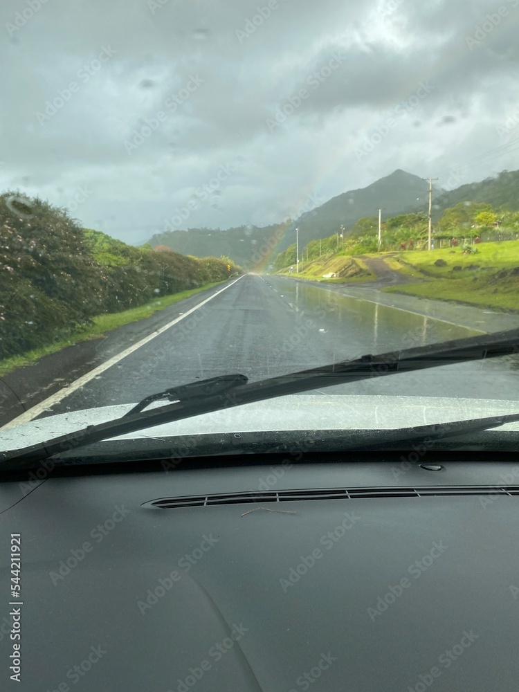 Obraz premium car on the road with raimbow