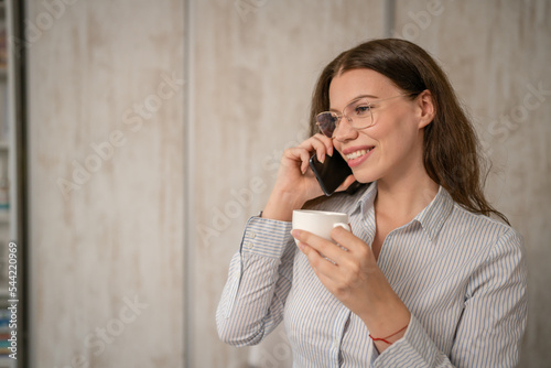 one woman businesswoman standing at office at work using mobile phone