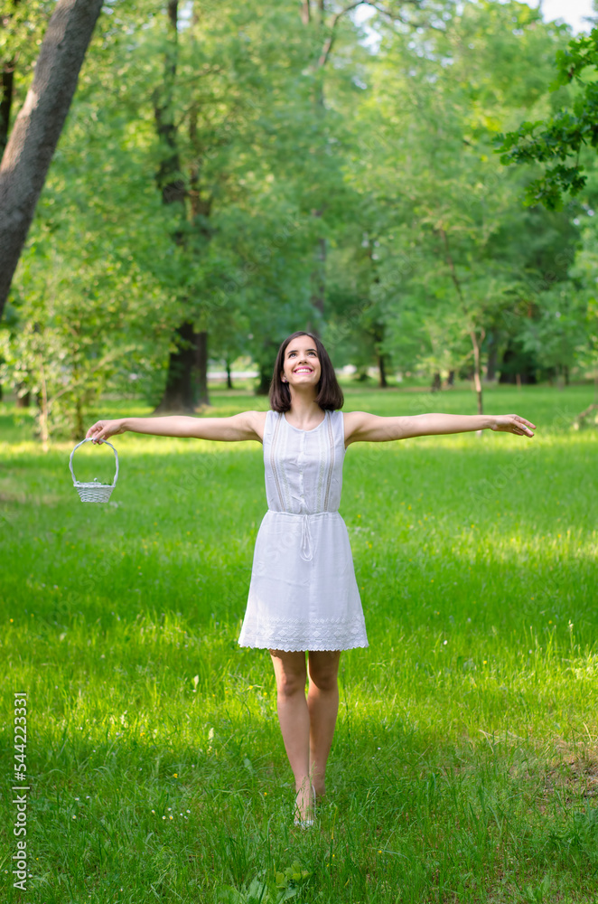 Young smiling woman picking flowers on the summer meadow Young smiling woman picking flowers on the summer meadow