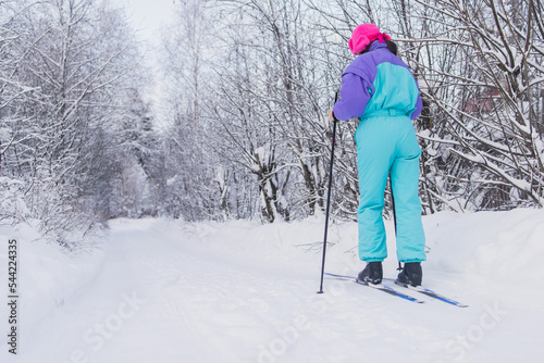 Beautiful cold forest view of ski run track on ski resort, winter day on a slope, pist, nordic skier on the track in winter, process of cross-country skiing in the woods