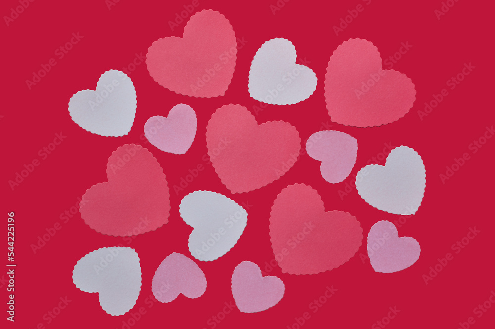 Random pink hearts on red background