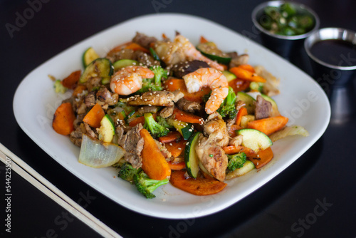 Asian plates with rice and vegetables on top. Japanese food.