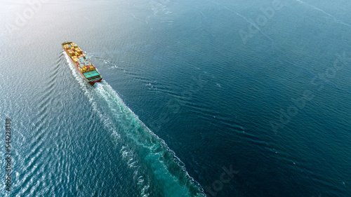 cargo maritime ship with contrail in the ocean ship carrying container and running for export concept technology freight shipping by ship smart service forwarder. Stern of container ship