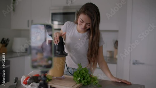 Girl content creator taking selfie video of cooking for social media