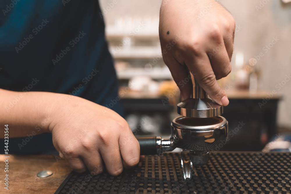 barista making a coffee from coffee powder. closeup of small business of coffee shop.