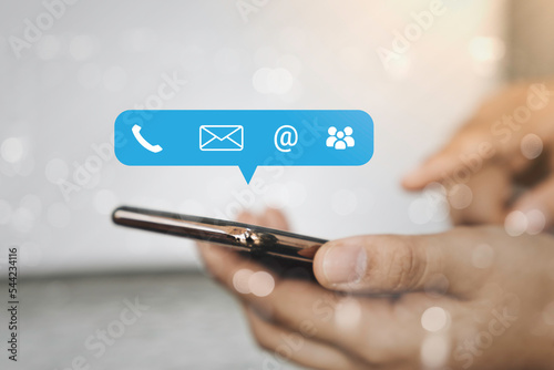 Contact us or Customer support hotline people connect. Business people using a smartphone with the (email, call phone, mail) icons.