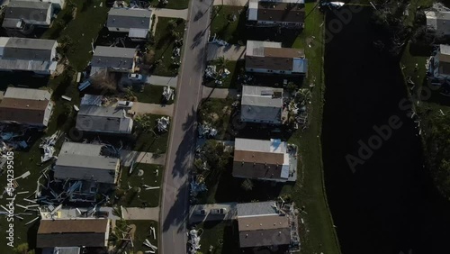 downward aerial view of the destruction caused at a mobile home park atter hurricane Ian.  Debris is everywhere below photo