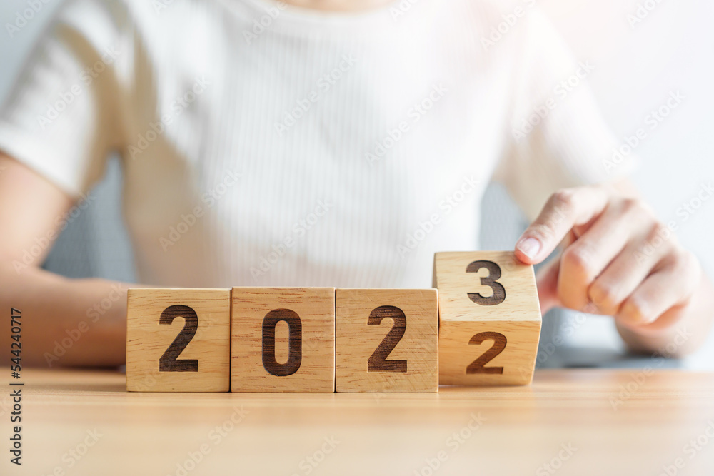 2022 change to 2023 year block on table. goal, Resolution, strategy, plan, start, budget, mission, action, motivation and New Year concepts - obrazy, fototapety, plakaty 