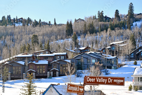 Vacation homes on a snowy tree lined hillside in the Park City and Deer Valley ski areas during winter in the Wasatch Mountains near Salt Lake City, Utah photo