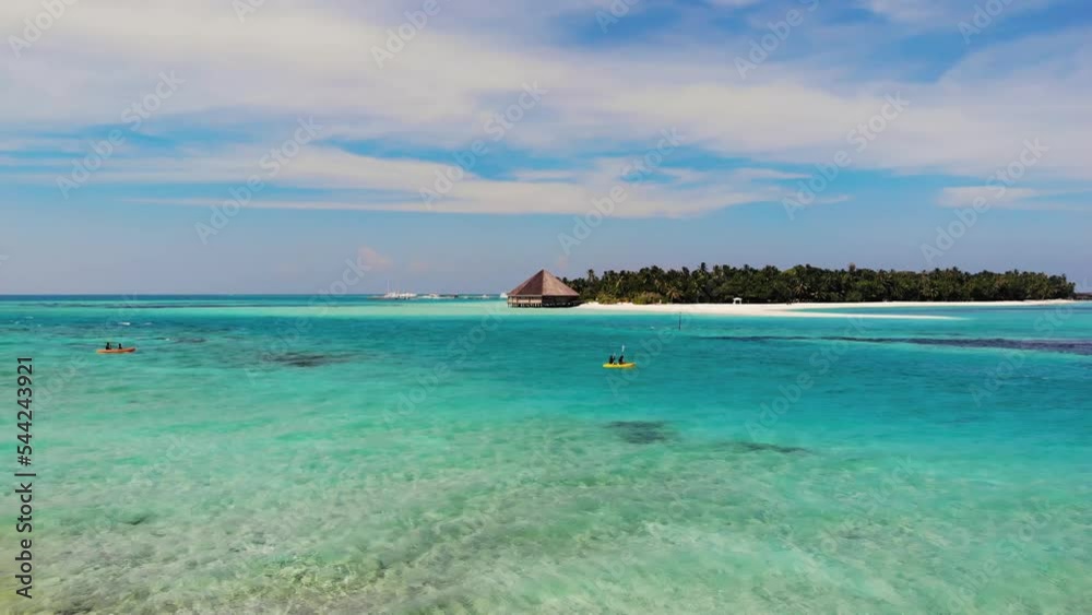Tourists are canoeing near the Maldivian island. Maldives background. Tourists are canoeing near the Maldivian island. Maldives background.