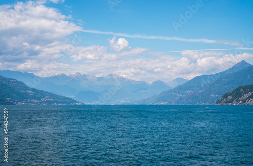 Beautiful panoramic view of Lake Como and the green Swiss Alps in the background on a sunny summer day. Lombardy, Italy.