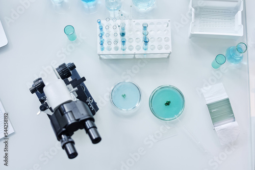 Above view of glassware, microscope and other equipment for carrying out new scientific investigation in clinical laboratory