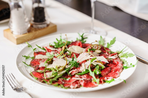 beef carpaccio with cheese and arugula