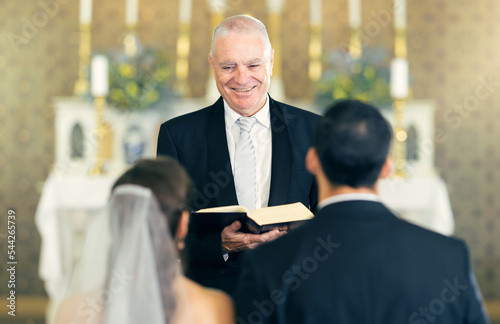 Bild auf Leinwand Wedding, priest and couple at the altar saying vows while getting married in a church for commitment, love and care
