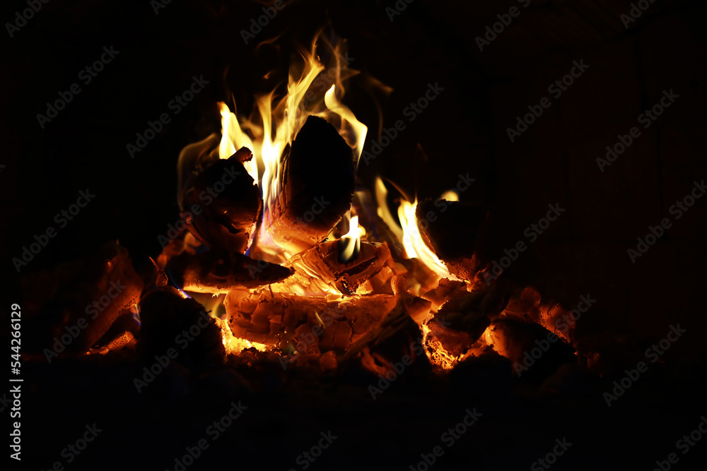 Background of the flame in the oven. Tongues of fire in a brick fireplace. Fire texture. Background of the flame in the oven. Tongues of fire in a brick fireplace. Fire texture.