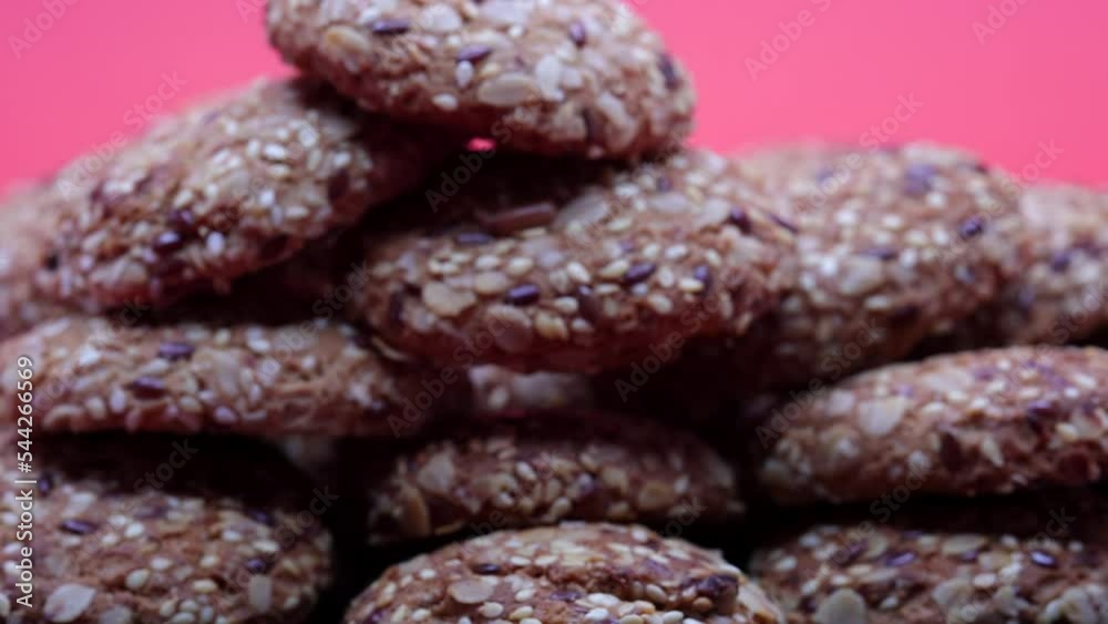 Oatmeal Cookies With Sesame Seeds On A Plate On A Red Background. Zoom In Dolly Slider Shot. 60 FPS, 4k Oatmeal Cookies With Sesame Seeds On A Plate On A Red Background. Zoom In Dolly Slider Shot. 60 FPS, 4k