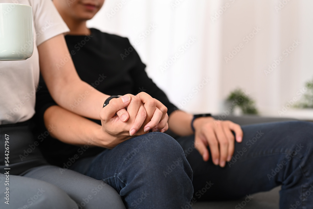 Close up view of young couple holding hands. Concept of expressing love feelings, trust care honesty in relationship Close up view of young couple holding hands. Concept of expressing love feelings, trust care honesty in relationship