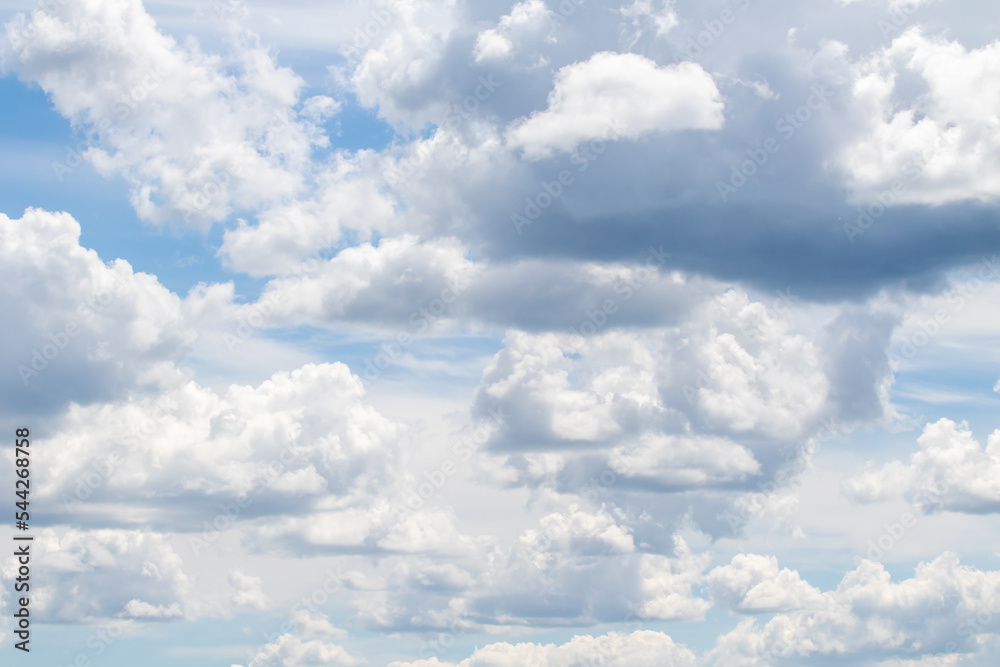 White clouds on the blue sky, bright background of the summer sky. White clouds on the blue sky, bright background of the summer sky.