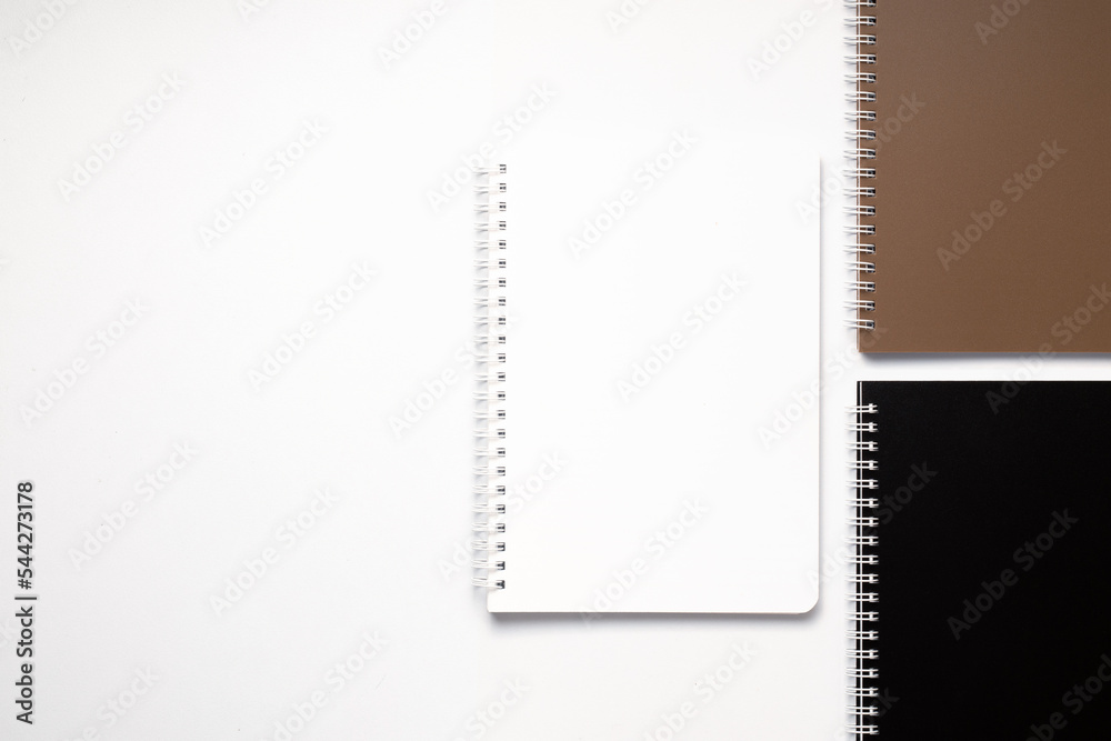 School notebook on a white background, spiral notepad on a table. flatlay School notebook on a white background, spiral notepad on a table. flatlay