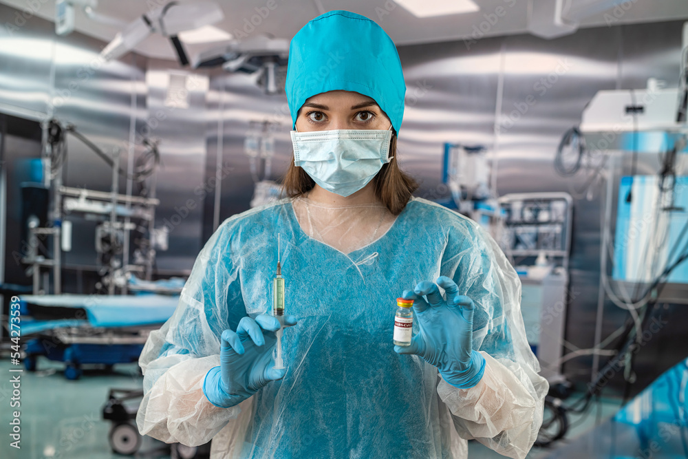 nurse wears a blue uniform wearing rubber latex blue gloves during complex surgical operation. nurse wears a blue uniform wearing rubber latex blue gloves during complex surgical operation.