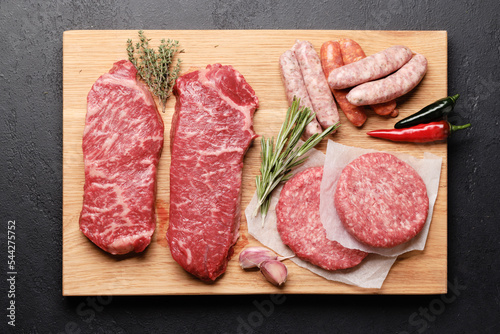 Various raw meat. Steaks, sausages, burgers and spices
