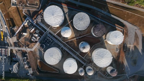 Top down aerial of fuel tanker truckers filling with chemicals and gasoline, diesel, gas. photo