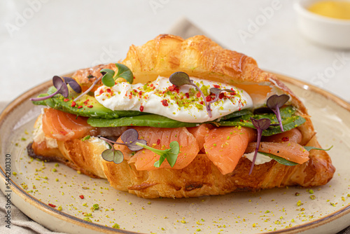 Portion of gourmet salmon croissant sandwich