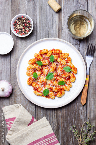 Gnocchi with tomato sauce, basil and Parmesan cheese. Healthy eating. Vegetarian food. Diet.