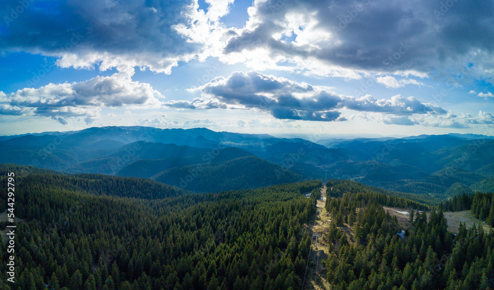 Valley of Rhodope Mountains is covered with fog and clouds. Mountain lift to top. Panorama, top view