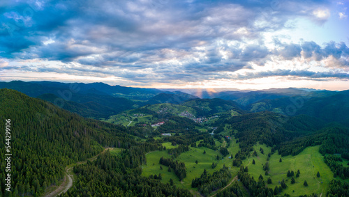 Valley of Balkan mountains with fog  sunny clouds and forests. Village Pamporovo. Panorama  top view