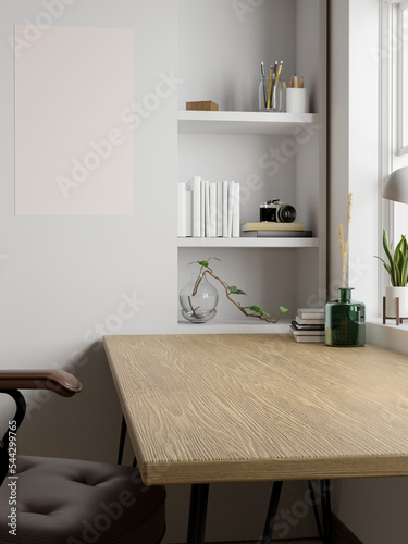 Minimal Scandinavian home workspace with copy space on minimal wood table, blank poster on wall