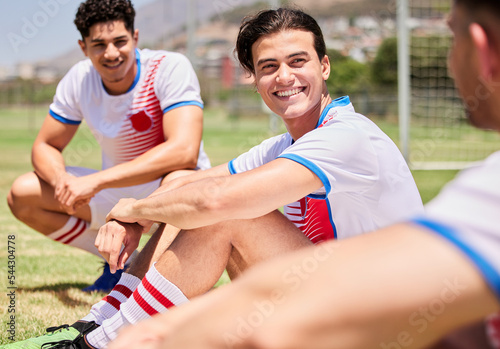 Soccer, team and men talking, smile and talk after game, training and practice outdoor on a field or pitch. Football, fitness and teamwork with soccer player happy, workout and collaboration on grass