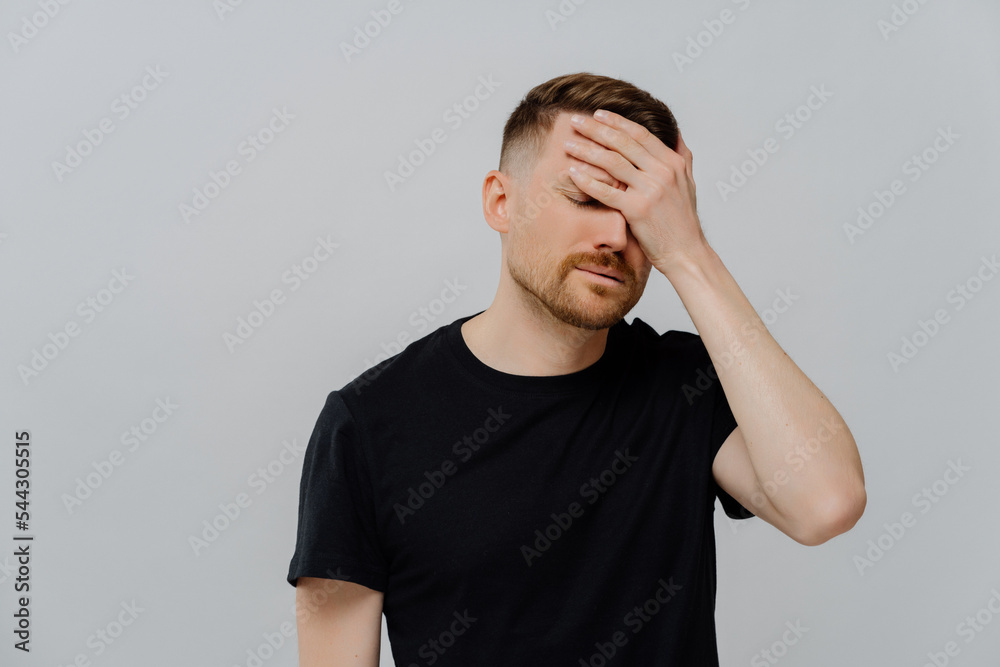 Disappointed man being upset because of doing mistake, feeling of despondency and dejection Disappointed man being upset because of doing mistake, feeling of despondency and dejection
